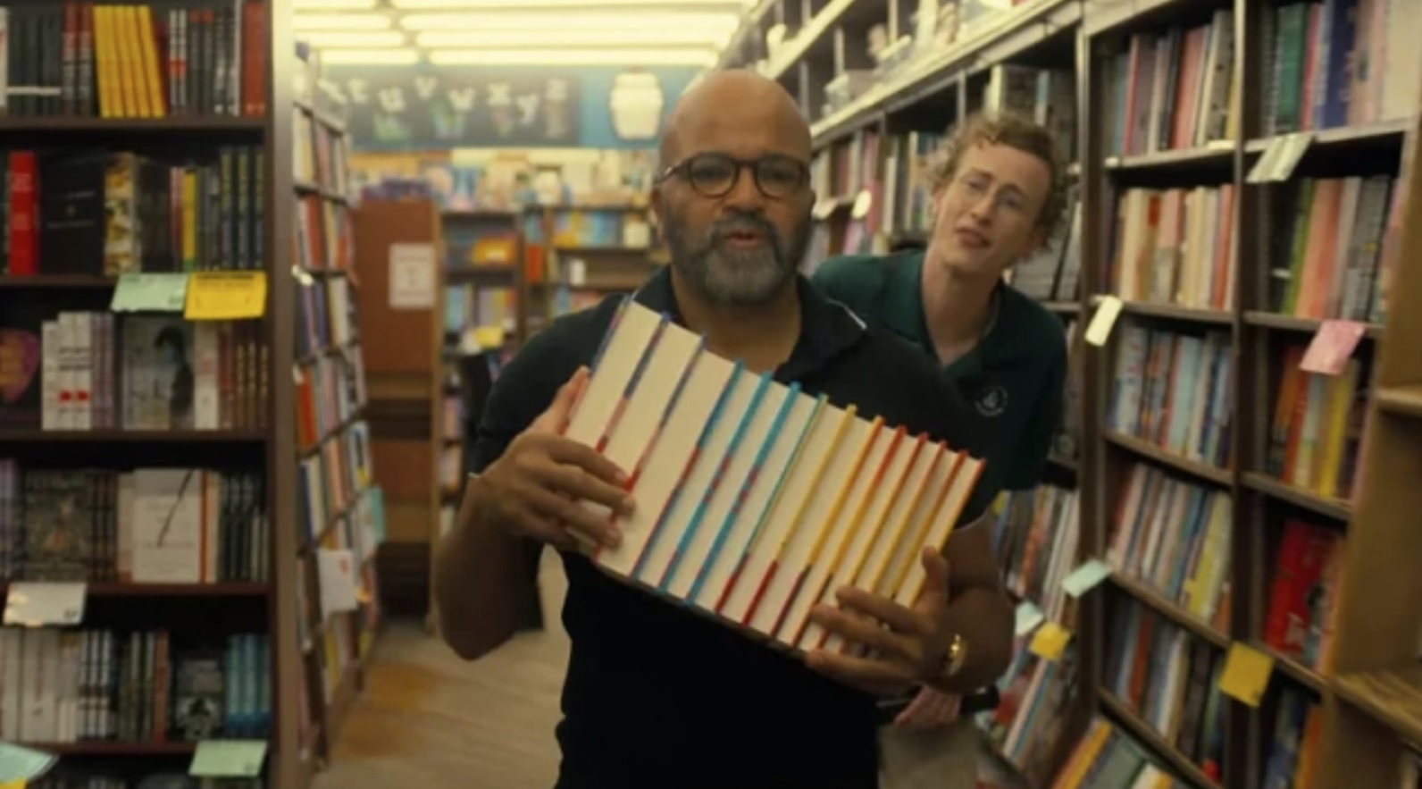 Paul Hunham (Jeffrey Wright) repositions his books in the bookstore in Cord Jefferson's "American Fiction".