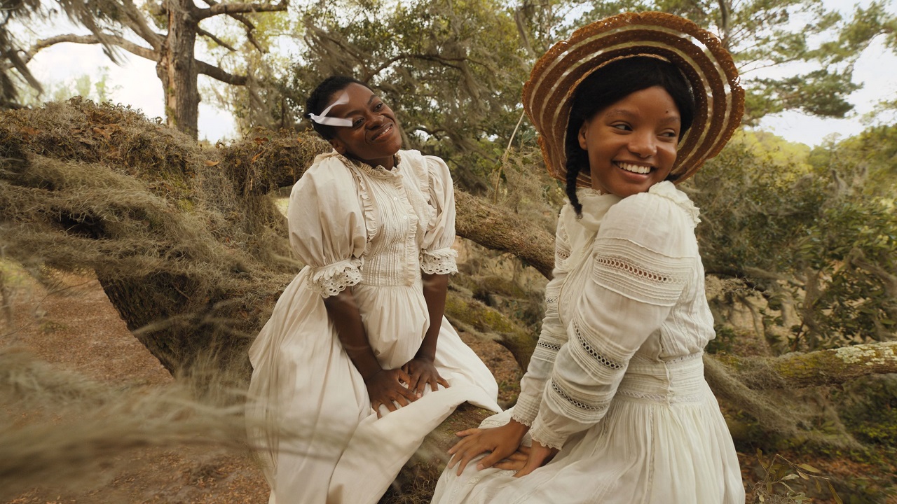 Young Celie and Netty sitting on a tree branch in The Color Purple