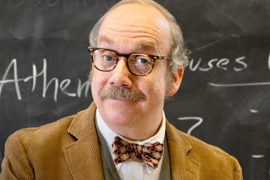 Paul Giamatti as Paul Hunham standing in front of a blackboard in Alexander Payne's "The Holdovers"