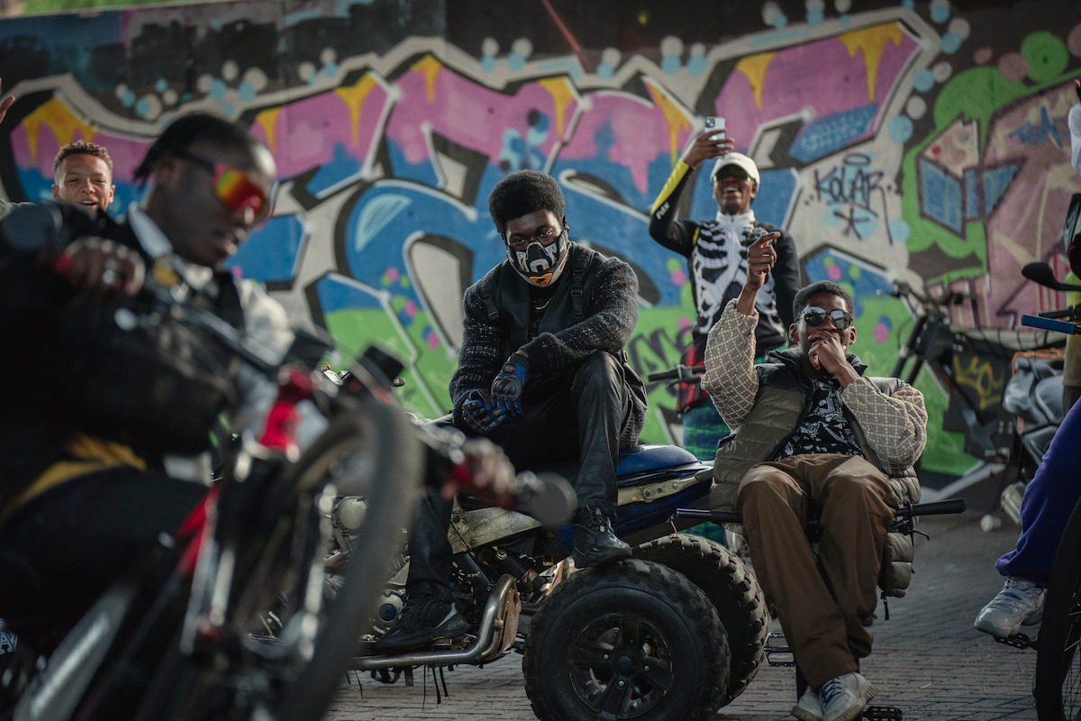 Gang members in The Kitchen sitting on bikes.