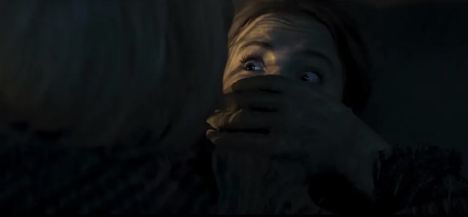 Iris (Freya Allan) looking terrified with a hand over her mouth in "Baghead"