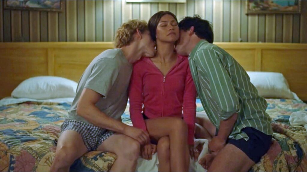 The two tennis pros kiss Zendaya on the neck in Challengers