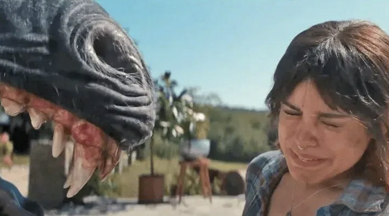 The angry parent unicorn snarling in the face of Ridley in Death of a Unicorn