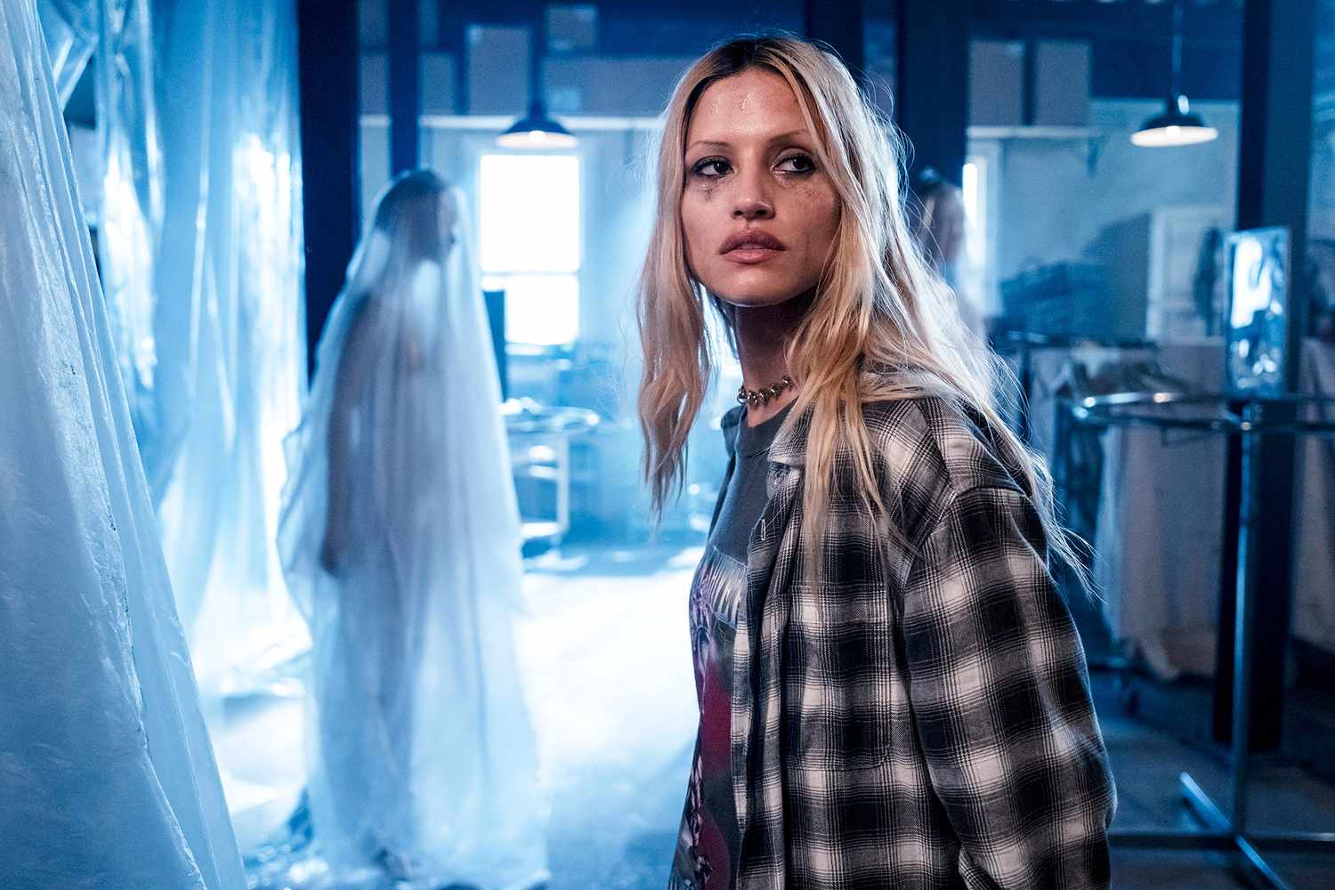 Tyler looking scares while walking around a spooky warehouse in "I Know What You Did Last Summer"