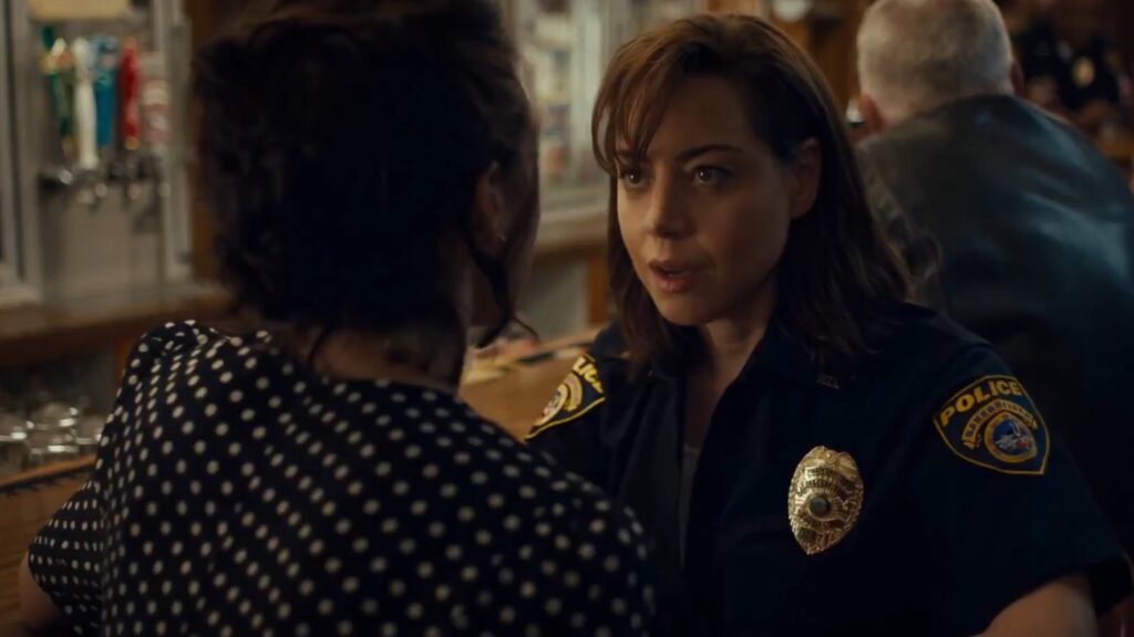 Margaret Qualley at Honey about to be fingered by police officer MG Falcone (Aubrey Plaza) in Honey Don't.