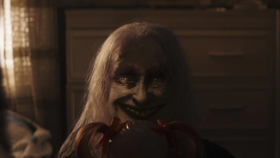 A ghoulish old woman plays peek-a-boo in The Conjuring: Last Rites