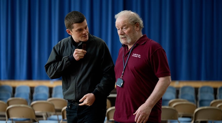 Robert (Robert Aramayo) with caretaker Tommy (Peter Mullen) in I Swear