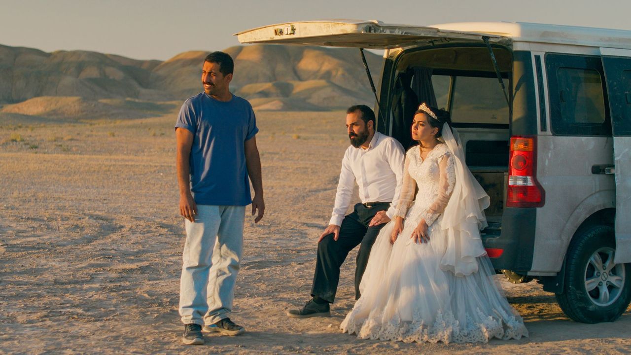 Vahid (Vahid Mobasseri), Ali (Majid Panahi) and Golrokh (Hadis Pakbaten) near their mini-van in the desert in It Was Just An Accident.