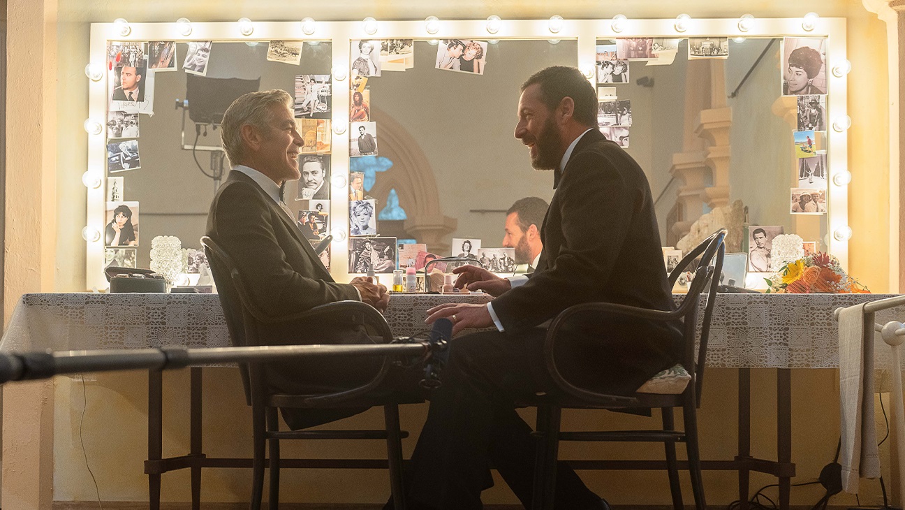 Jay Kelly (George Clooney) and his agent Ron (Adam Sandler) share a joke in his dressing room in the Netflix production.