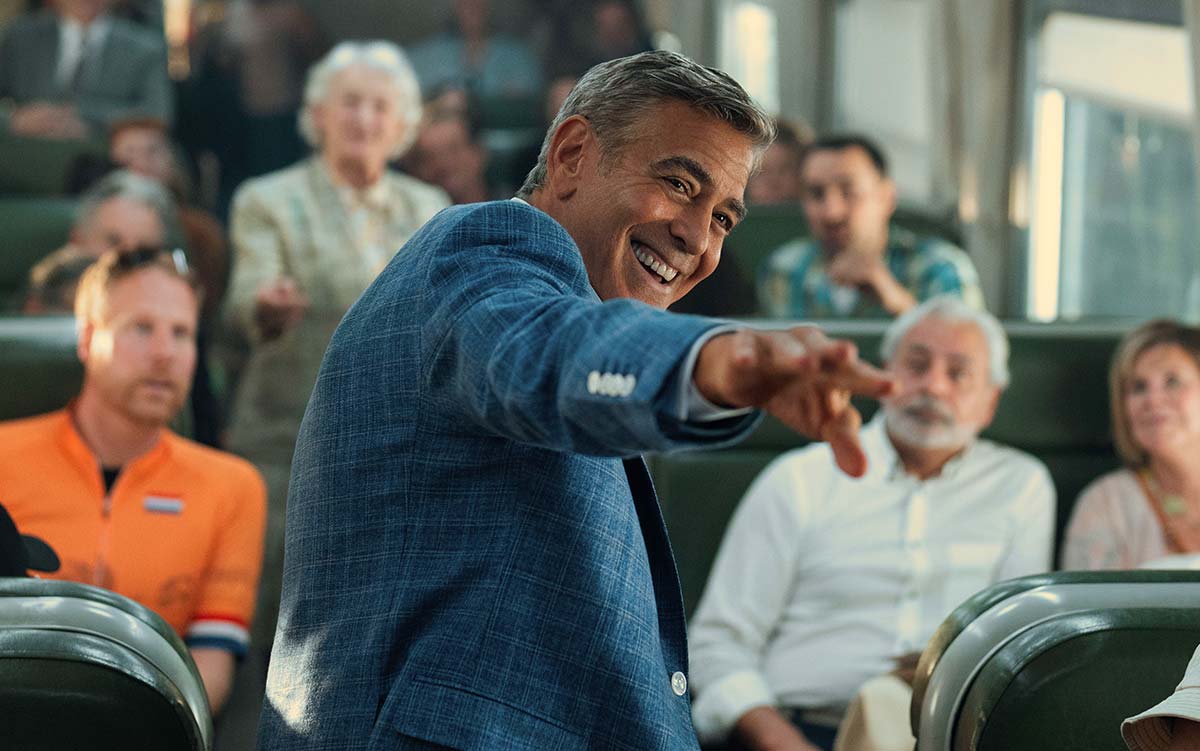 George Clooney as Jay Kelly on a French train in a Netflix production.