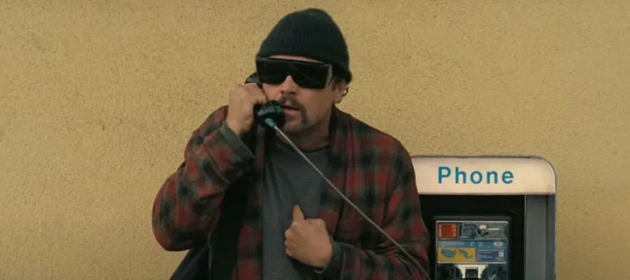Bob (Leonardo DiCaprio) getting frustrated on a payphone in One Battle After Another