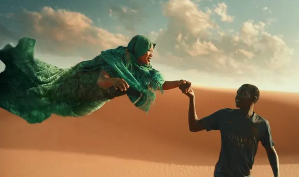 A fantasy scene sees Seydou Starr holding a flying woman's hand in the desert in Io Capitano
