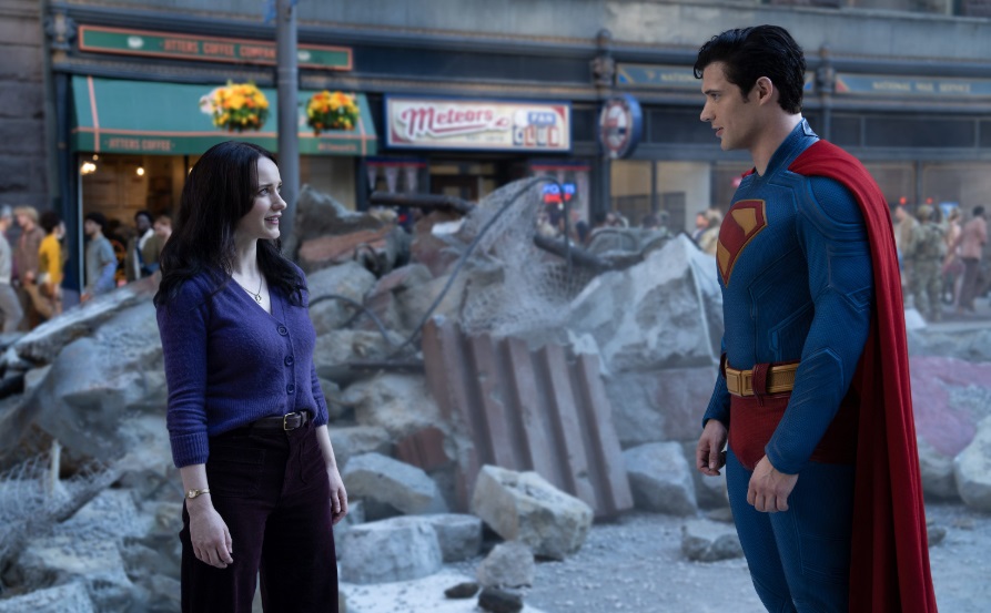 Lois Lane and Superman standing in a street with building rubble all around.