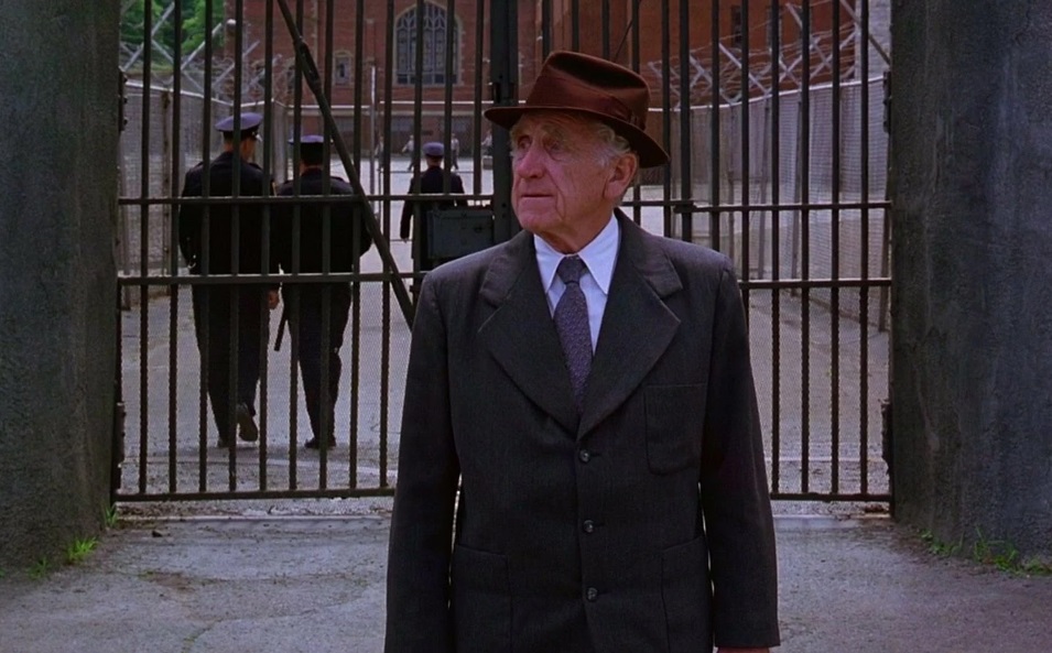 Lifer Brooks standing outside the prison gates after release in The Shawshank Redemption.