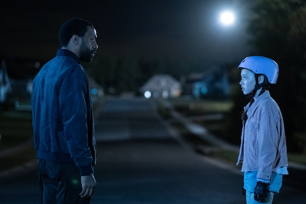 Marty talks to skater girl Iris in the street at night in The Life of Chuck