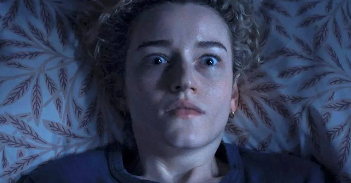 Janine (Julie Garner) stares up at her bedroom ceiling in horror, in Weapons.