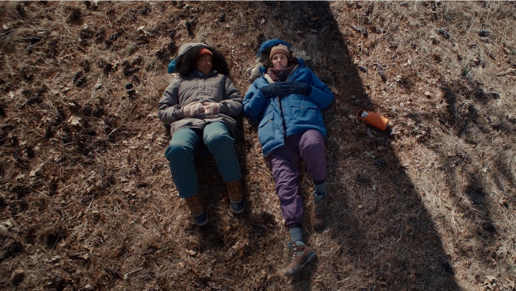 Lydie and Agnes lie in a field and talk in Sorry Baby