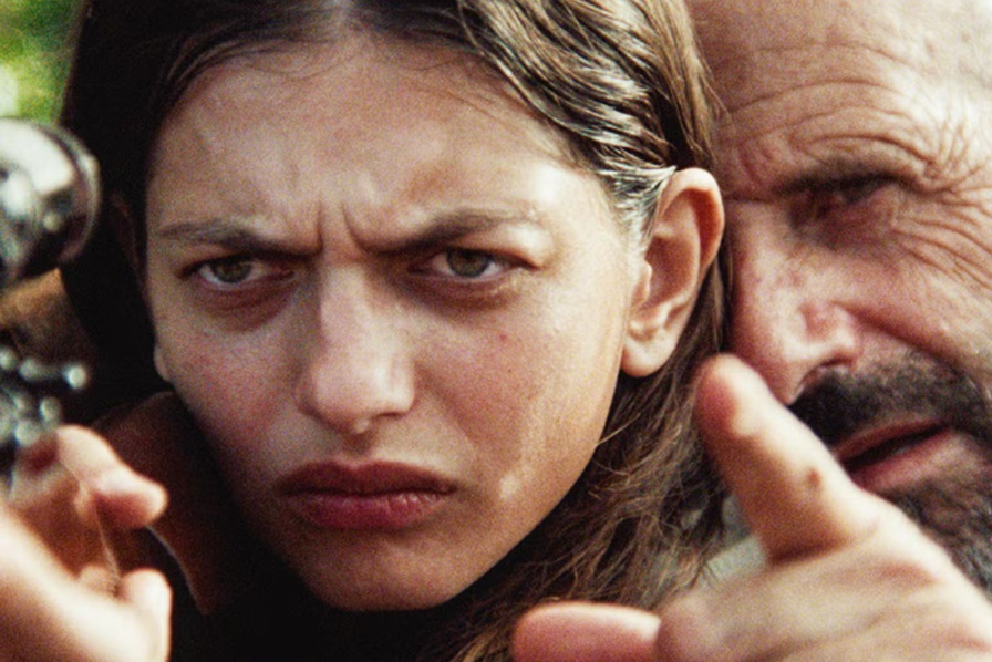 Saveriu Santucci (Pierre-Paul Savelli) teaches Lesia (Ghjuvanna Benedetti) to hunt with a rifle in The Kingdom.