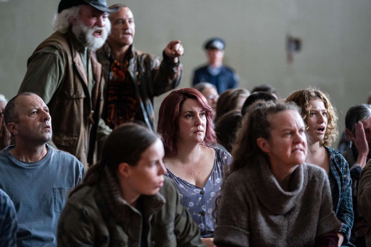 Anna (Melanie Lynskey) and her daughter Alisha (Madeleine McCarthy) sit while a crisis meeting erupts in anger in Pike River. 