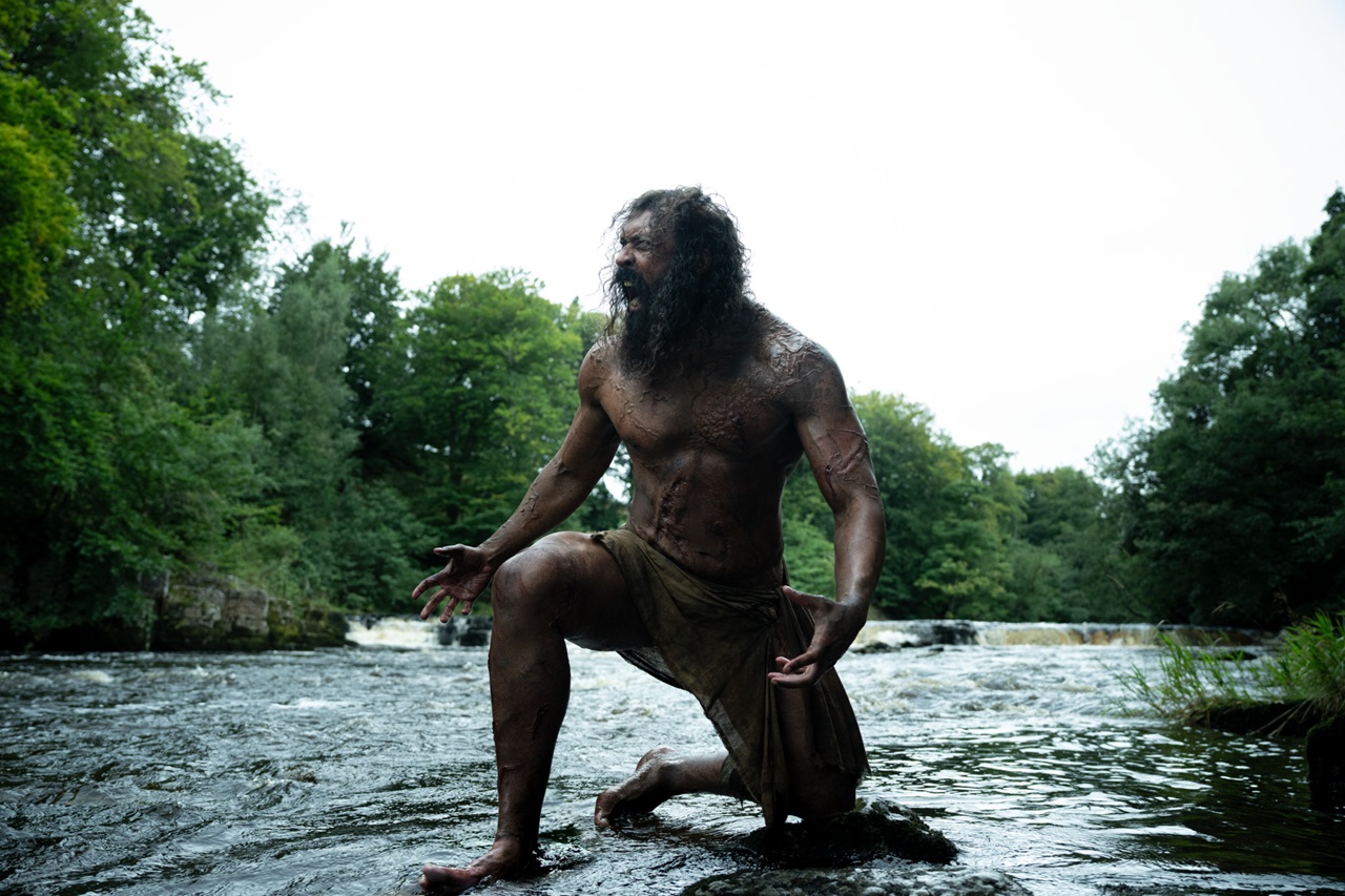 Samson (Chi Lewis-Parry) kneels in a river and roars in 28 Years Later: The Bone Temple