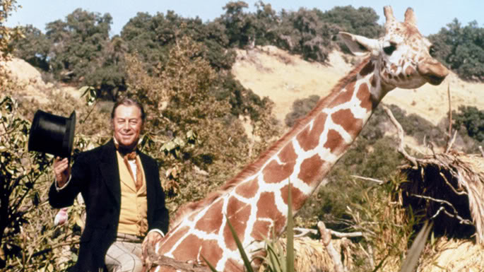 Rex Harrison as Doctor Dolittle sitting on a giraffe  - from the book Box Office Poison by Tim Robey