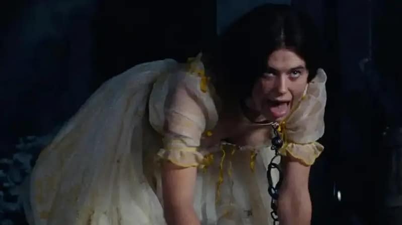 Isabella (Alison Oliver) play acting a dog in Emerald Fenell's "Wuthering Heights"