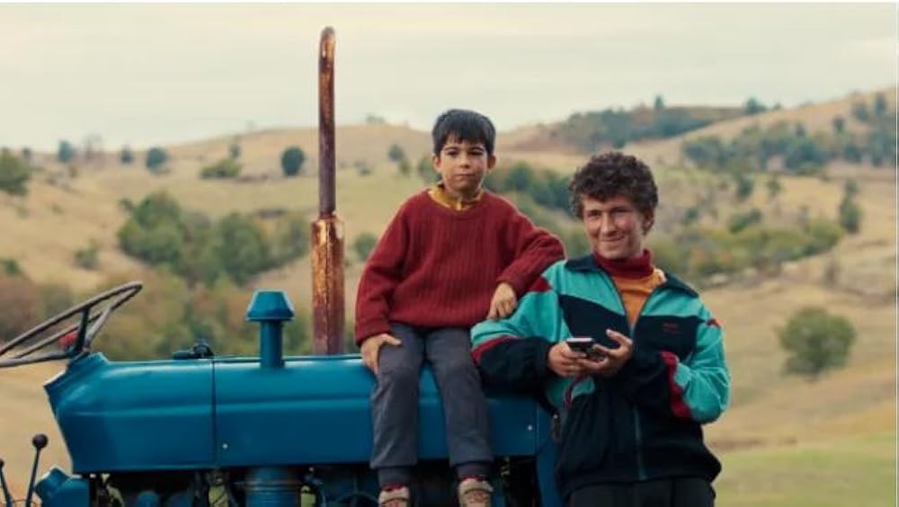DJ and Naim sit on a tractor in DJ Ahmet